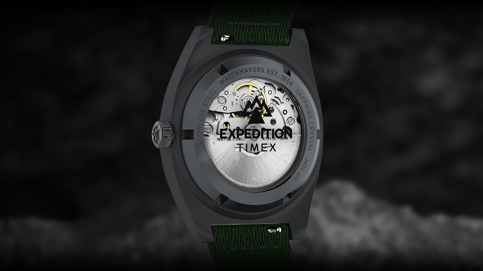 Rear view of the Timex Expedition® Capstone Automatic watch showing its exhibition caseback with visible automatic movement. The rotor displays the Expedition logo beneath sapphire crystal, highlighting mechanical precision and craftsmanship.