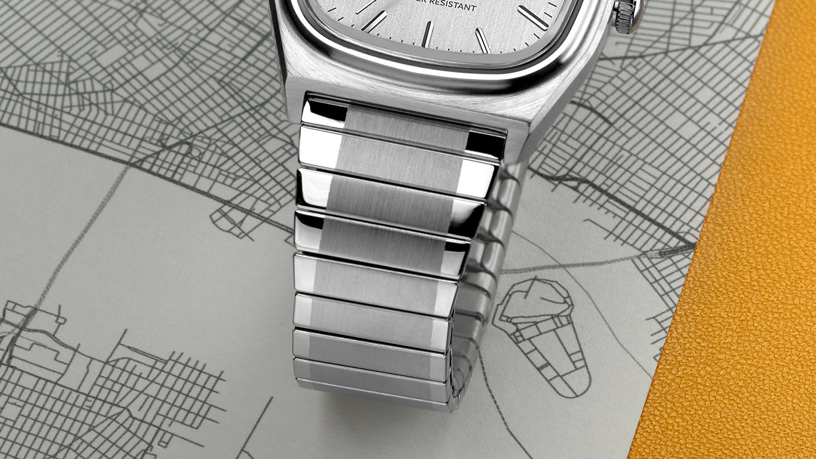 Close-up of the bracelet of the Timex® Automatic 1983 E Line Reissue highlighting the brushed and polished stainless-steel links and their seamless integration with the case.