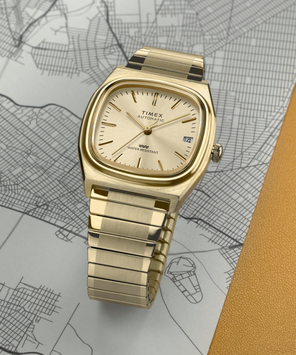 TW2Y07200 Timex® Automatic 1983 E Line Reissue 34mm Gold-Tone Expansion Band Watch Campaign Key Silhouettes (Beauty shots) Image