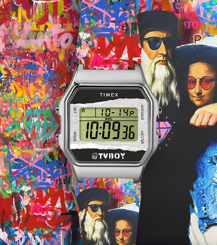 Digital Timex wristwatch from the Timex x TVBoy collaboration, featuring a stainless steel case and retro-style digital display reading '10:09:36'. The watch is set against a vibrant, graffiti-style background with multicolored abstract paint splashes. To the right of the watch face is a stylized mural by TVBoy depicting Leonardo da Vinci and the Mona Lisa wearing modern sunglasses and casual clothing, with a pink diamond graphic on da Vinci’s shirt.
