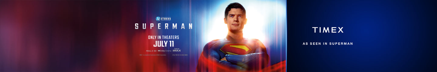 Promotional banner for the upcoming Superman movie from DC Studios, premiering in theaters on July 11. The banner features Superman standing heroically with a glowing background, wearing his iconic red and blue suit with a yellow “S” emblem on his chest. On the right side, the Timex logo appears with the tagline “As Seen in Superman,” indicating a brand partnership.
