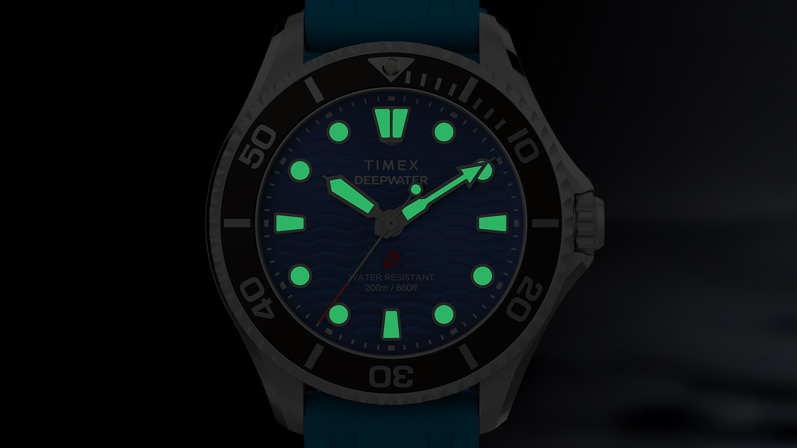 Front view of the Timex Deepwater Meridian 200 glowing in the dark, with luminescent markers and hands.