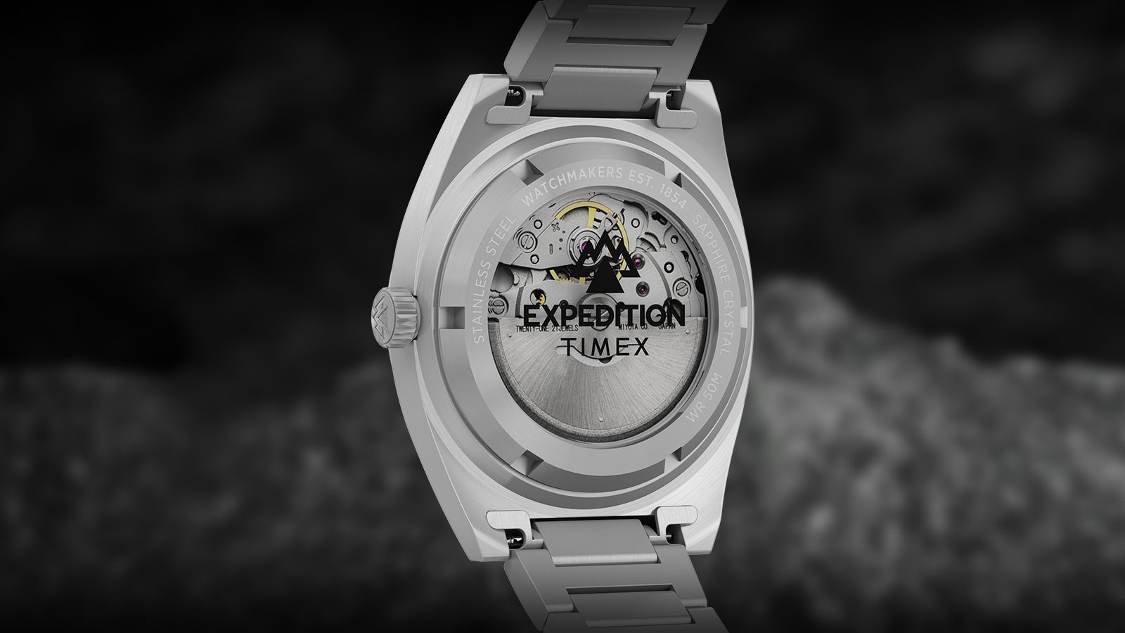 Rear view of the Timex Expedition® Capstone Automatic watch showing its exhibition caseback with visible automatic movement. The rotor displays the Expedition logo and mechanical components, emphasizing craftsmanship and reliability.