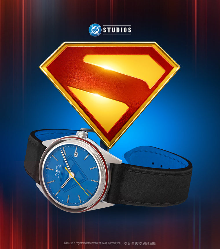 A Timex x Superman Marlin® Jet Automatic watch with a bold blue dial, yellow seconds hand, and Superman’s “S” emblem in the background, with DC Studios branding.