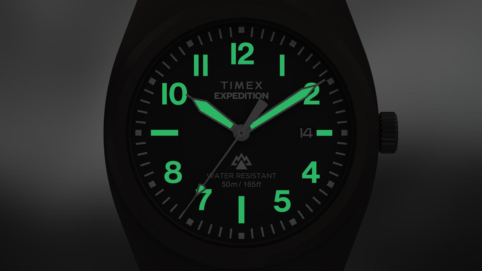 Close-up of the Timex Expedition® Capstone watch in low light, showing luminous green hands and numerals glowing against the black dial. The glow emphasizes visibility in dark environments.