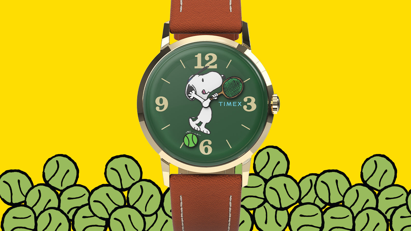 Close-up of the green Snoopy tennis dial on the Peanuts® x Timex Marlin® Hand-Wound watch, framed by a gold-tone case and brown leather strap above illustrated tennis balls.