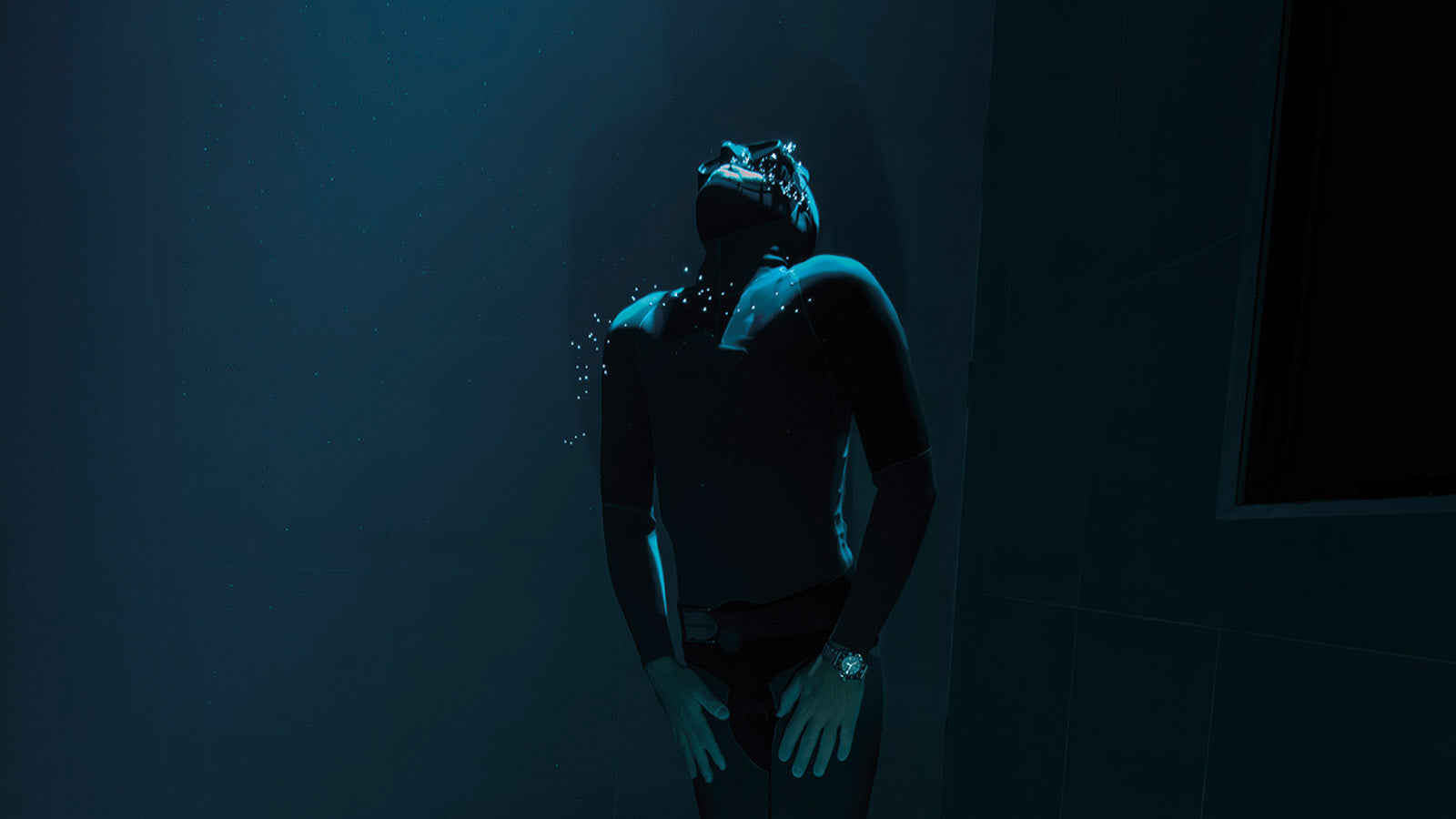 Underwater diver captured in blue lighting wearing the Timex Deepwater Reef 200, highlighting its durability and depth capability.