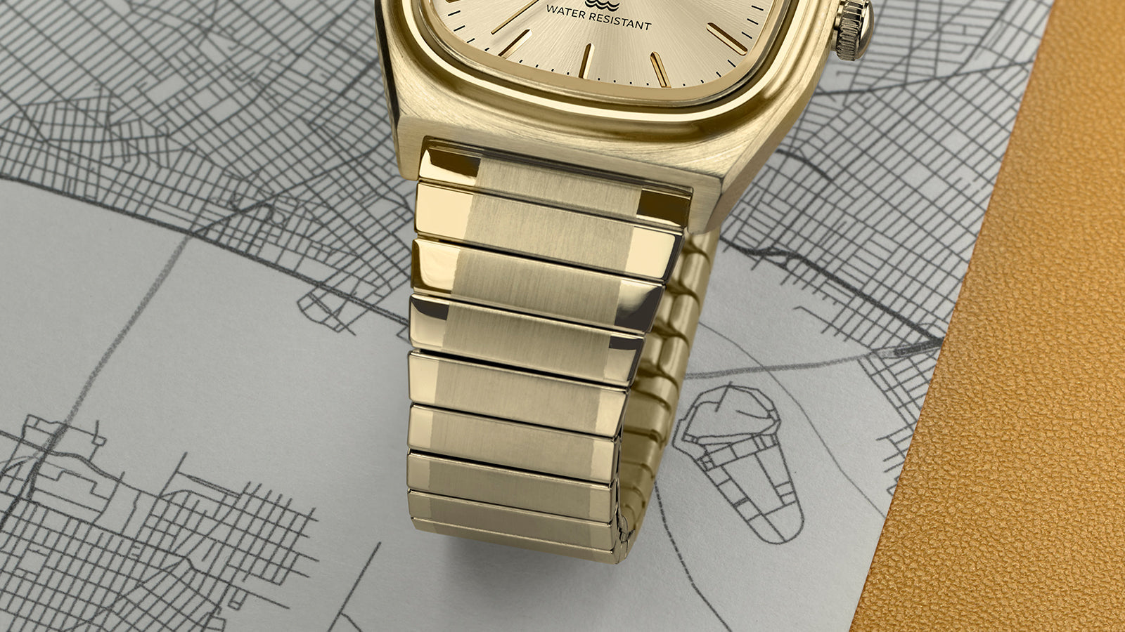 Detailed close-up of the Timex® Automatic 1983 E Line Reissue bracelet showing the brushed and polished gold-tone stainless-steel links.