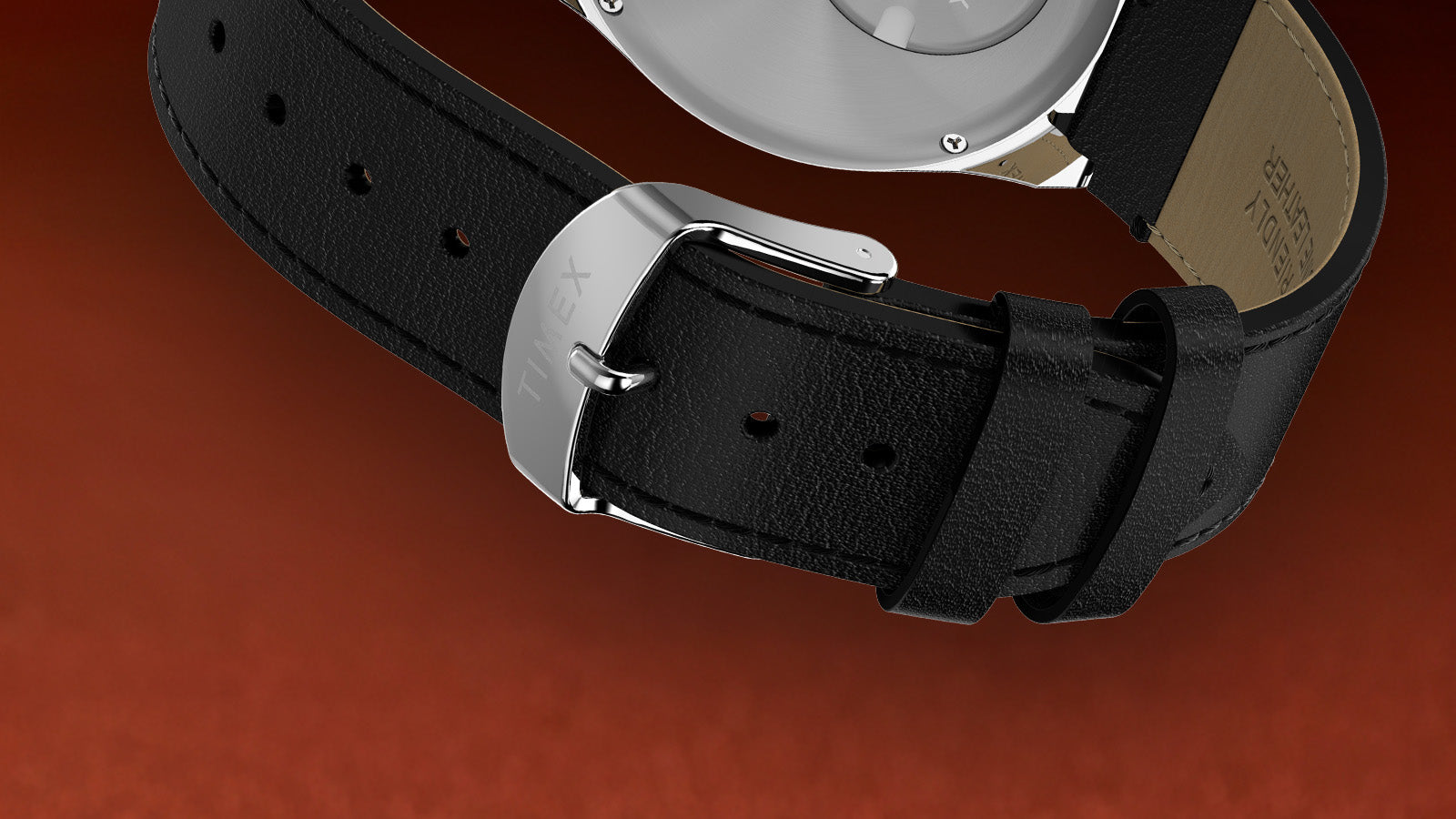 Detailed shot of the Q Timex Chronograph’s black leather strap and stainless steel buckle engraved with the Timex logo.