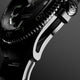 Macro side view of Timex Atelier watch case with brushed stainless steel finish, detailed crown engraved with "T" logo, and knurled bezel edge.