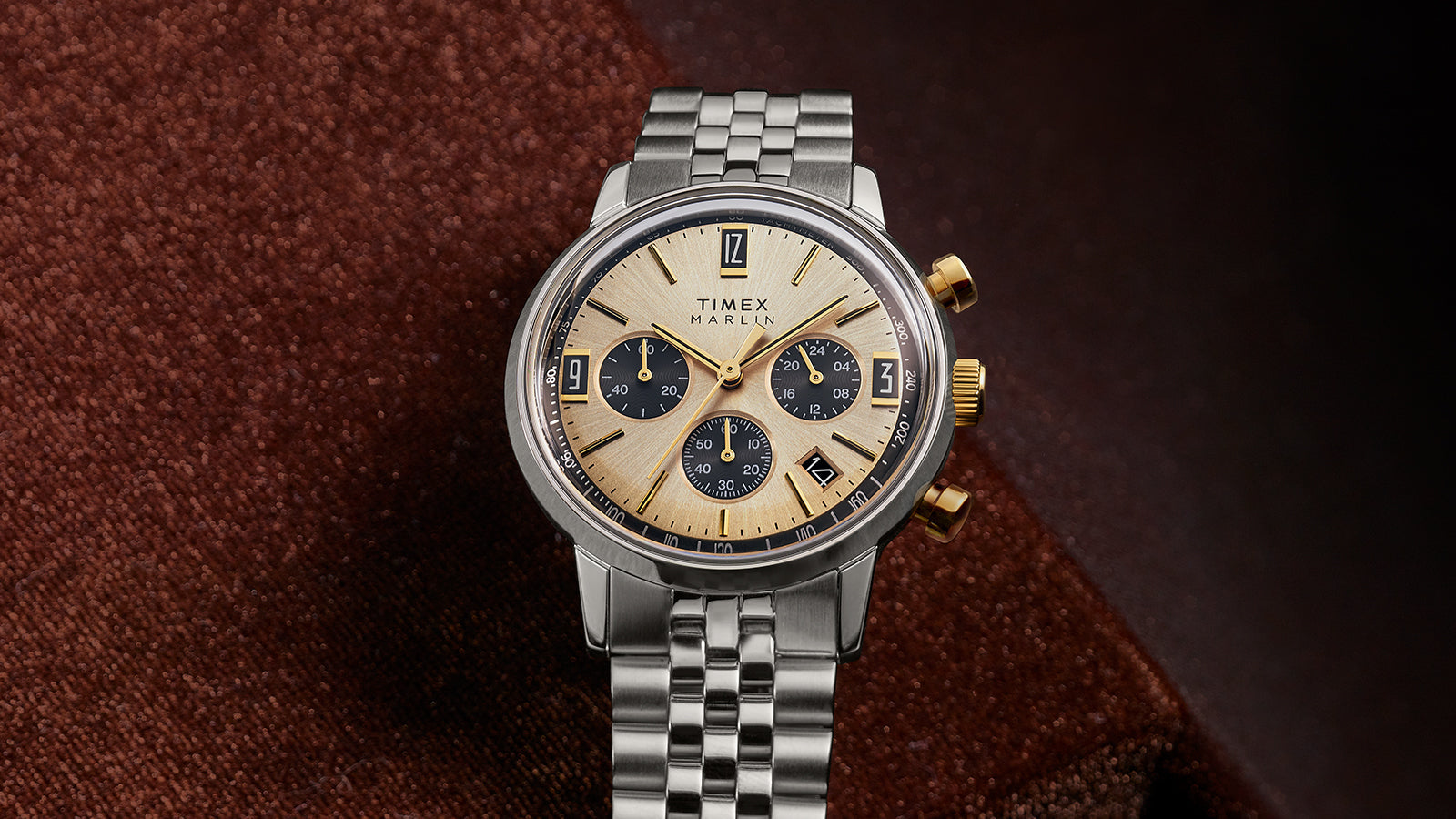 Front view of Timex Marlin Chronograph Tachymeter featuring champagne dial, gold-tone hands and pushers, and stainless-steel bracelet.