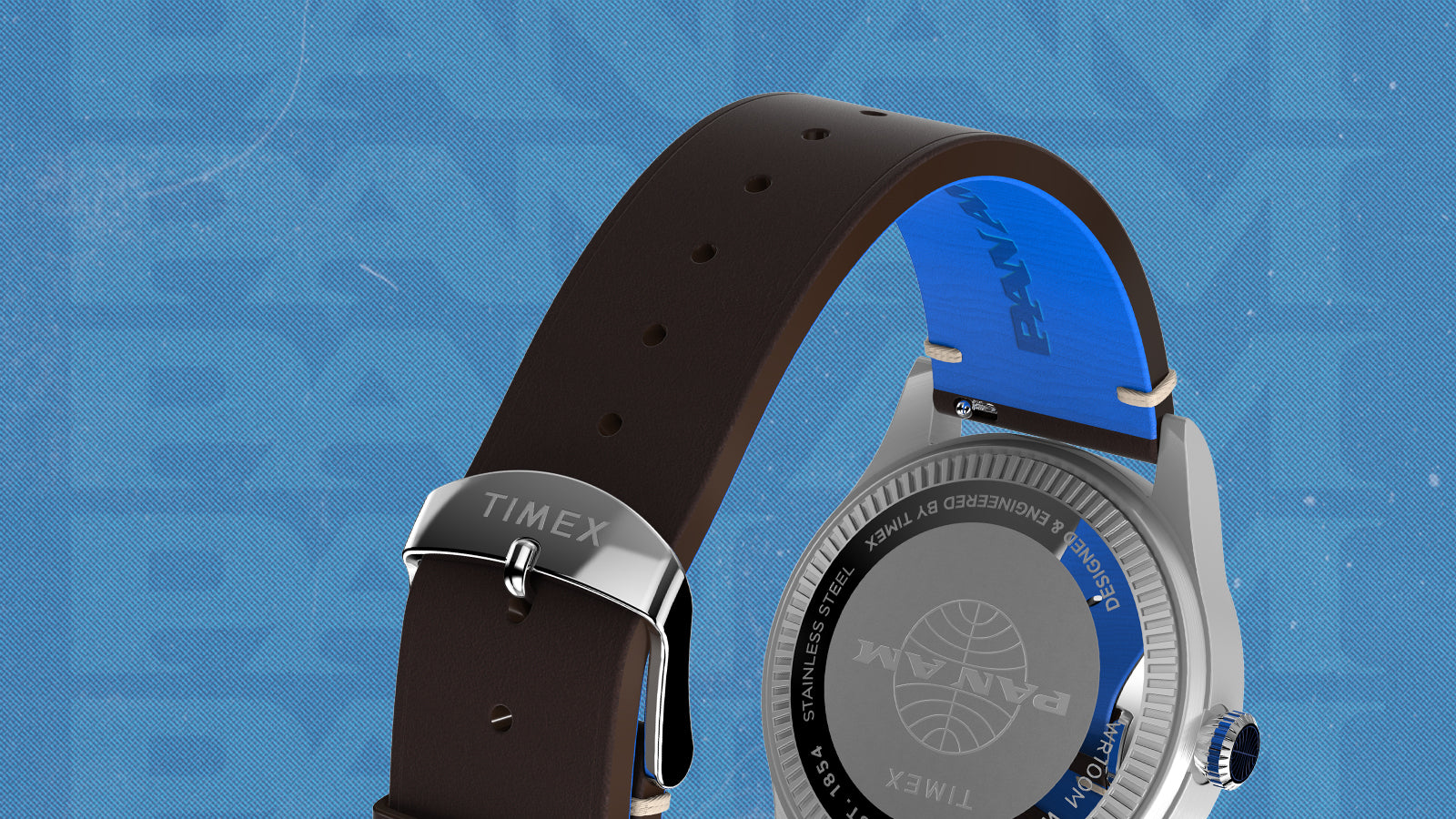 Rear and strap view of the Timex x Pan Am® Waterbury GMT watch showing the engraved Pan Am logo on the stainless-steel case back. The brown leather strap reveals a bright blue lining with embossed Pan Am branding and a polished buckle engraved with the Timex logo.