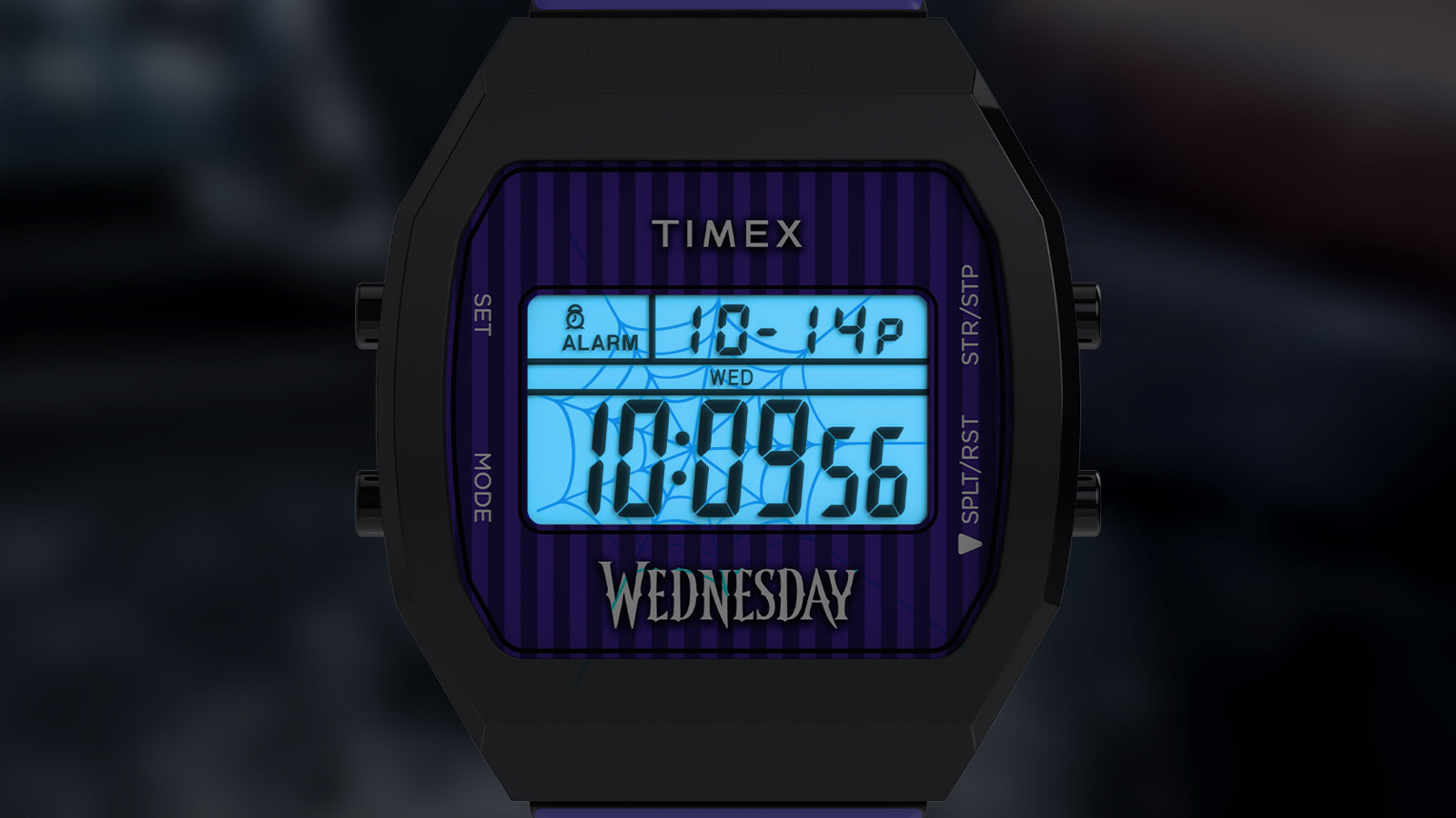 Timex x Wednesday T80 digital watch with INDIGLO® backlight activated, illuminating the display in blue. A subtle spiderweb graphic appears on the screen, enhancing the eerie aesthetic inspired by Wednesday Addams.