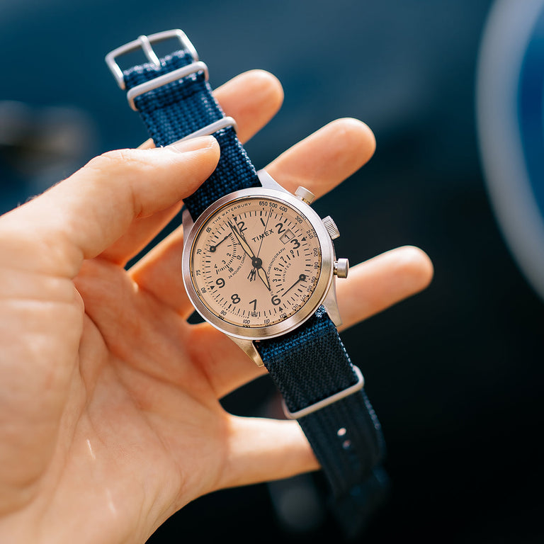 Close-up of the Timex Waterbury Traditional Fly-Back Chronograph’s durable navy woven fabric strap and brushed metal hardware.