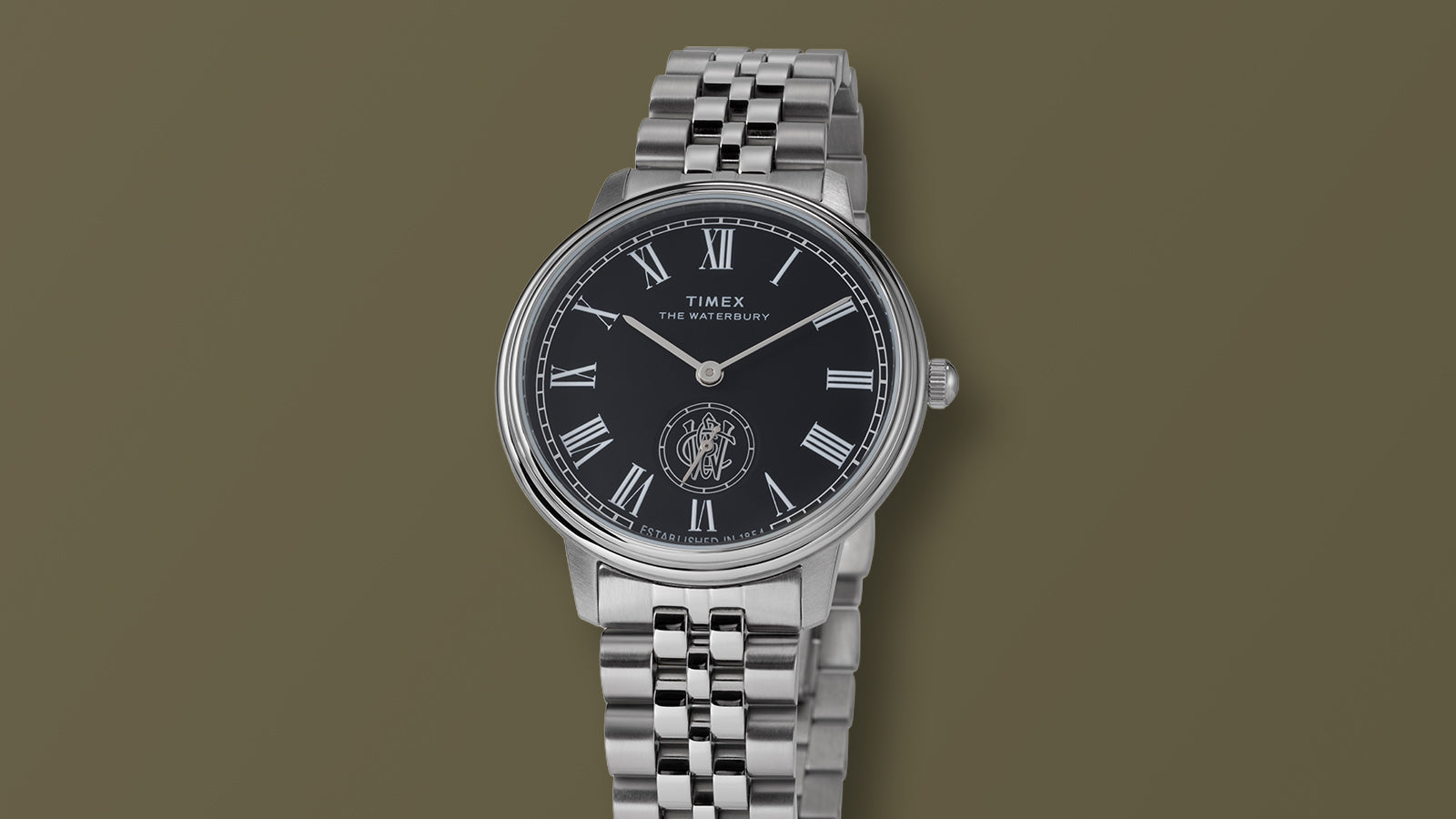 Front view of the Timex Waterbury Metropolitan Sub-Second watch displaying its black dial with white Roman numerals and sub-second dial above six o’clock.