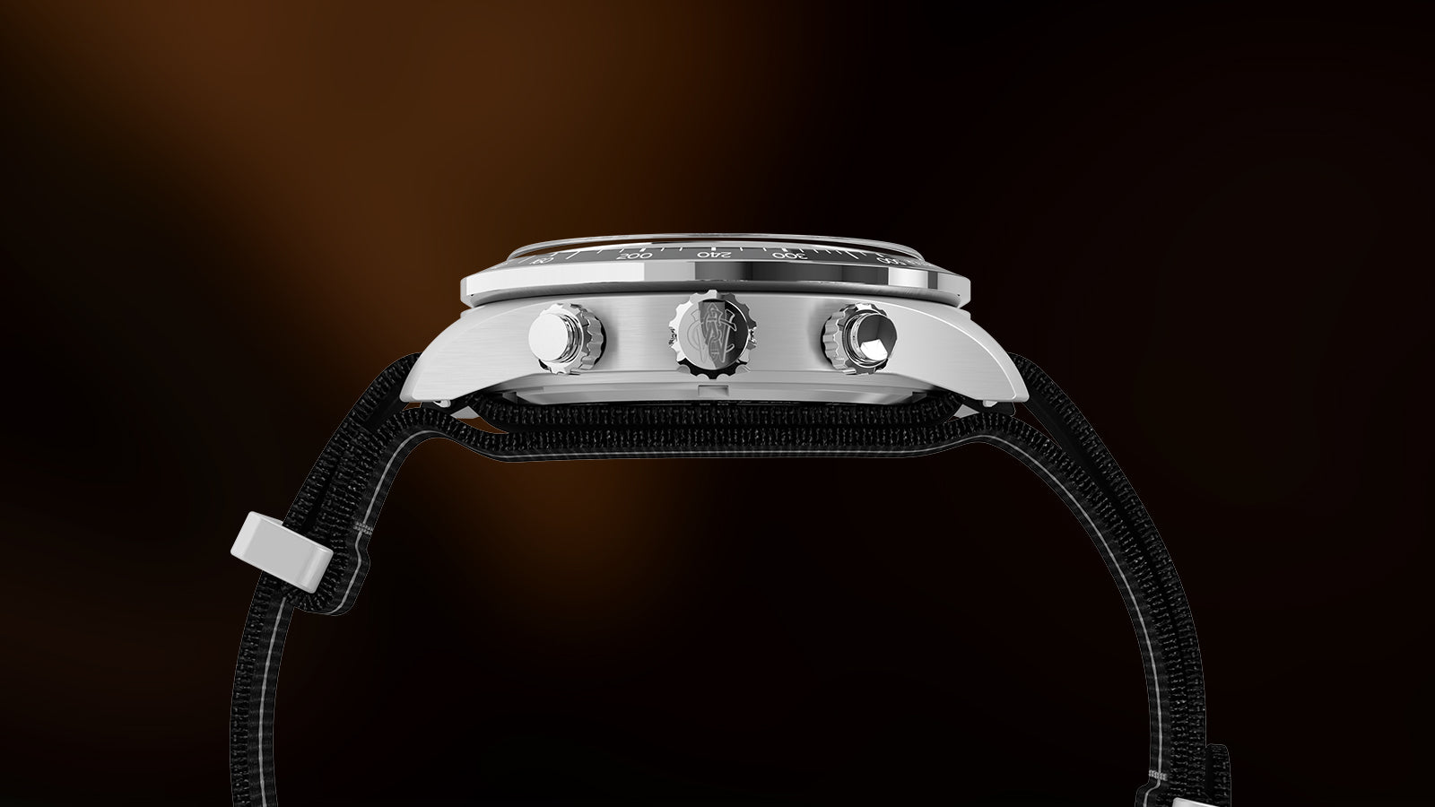 Side view of the Timex Waterbury Heritage Chronograph showing stainless-steel case, crown, and pushers with engraved Waterbury “W” logo.