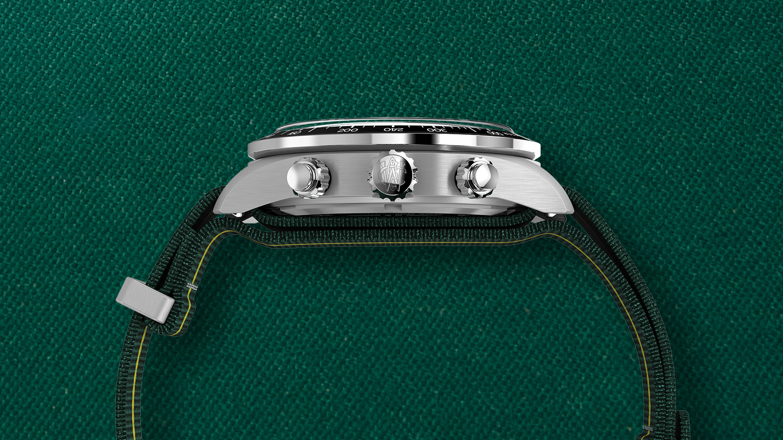 Side profile of the Timex Waterbury Heritage Chronograph showing brushed stainless-steel case, crown, and pushers engraved with the Waterbury “W” logo.