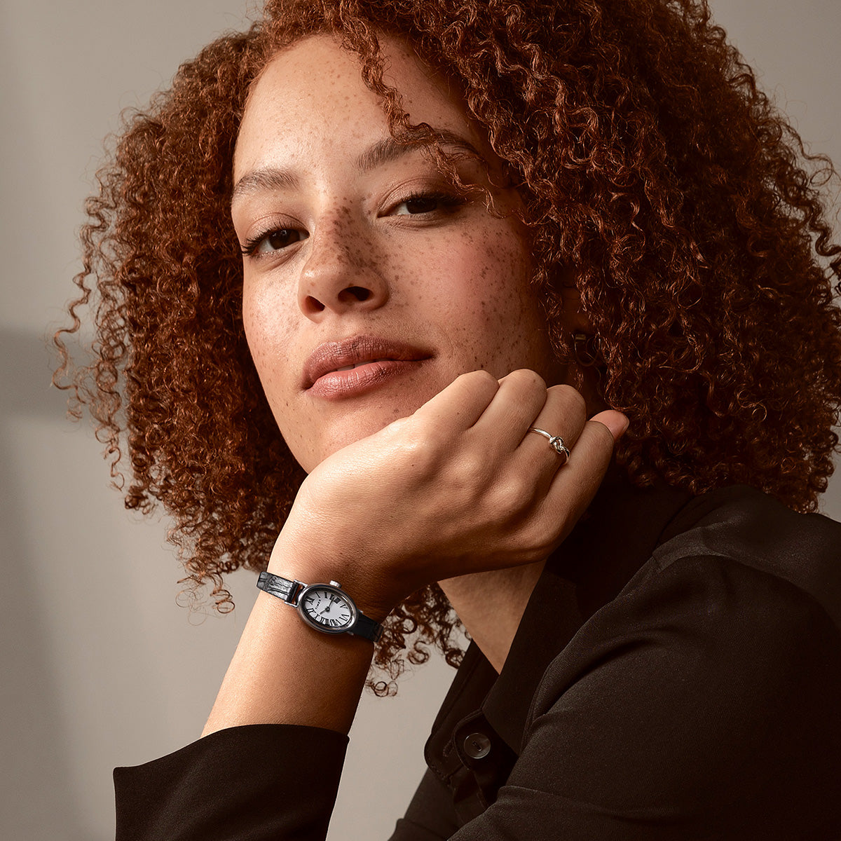 Profile view of a person smiling while wearing the TIMEX® Cavatina watch, highlighting its slim and elegant design.
