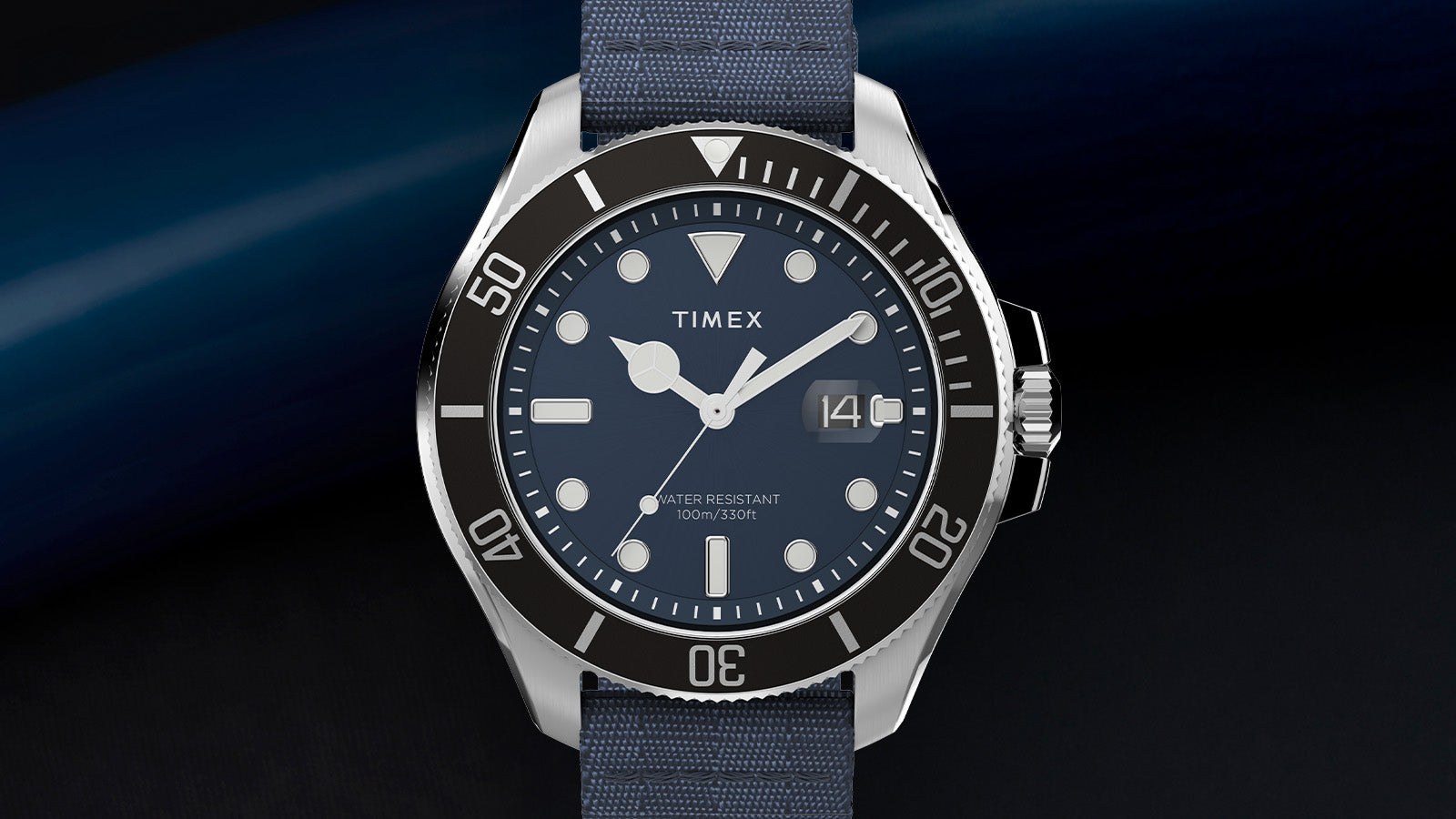 Front view of the TIMEX® Harborside Coast watch highlighting the polished stainless-steel case, blue dial, and blue fabric strap.