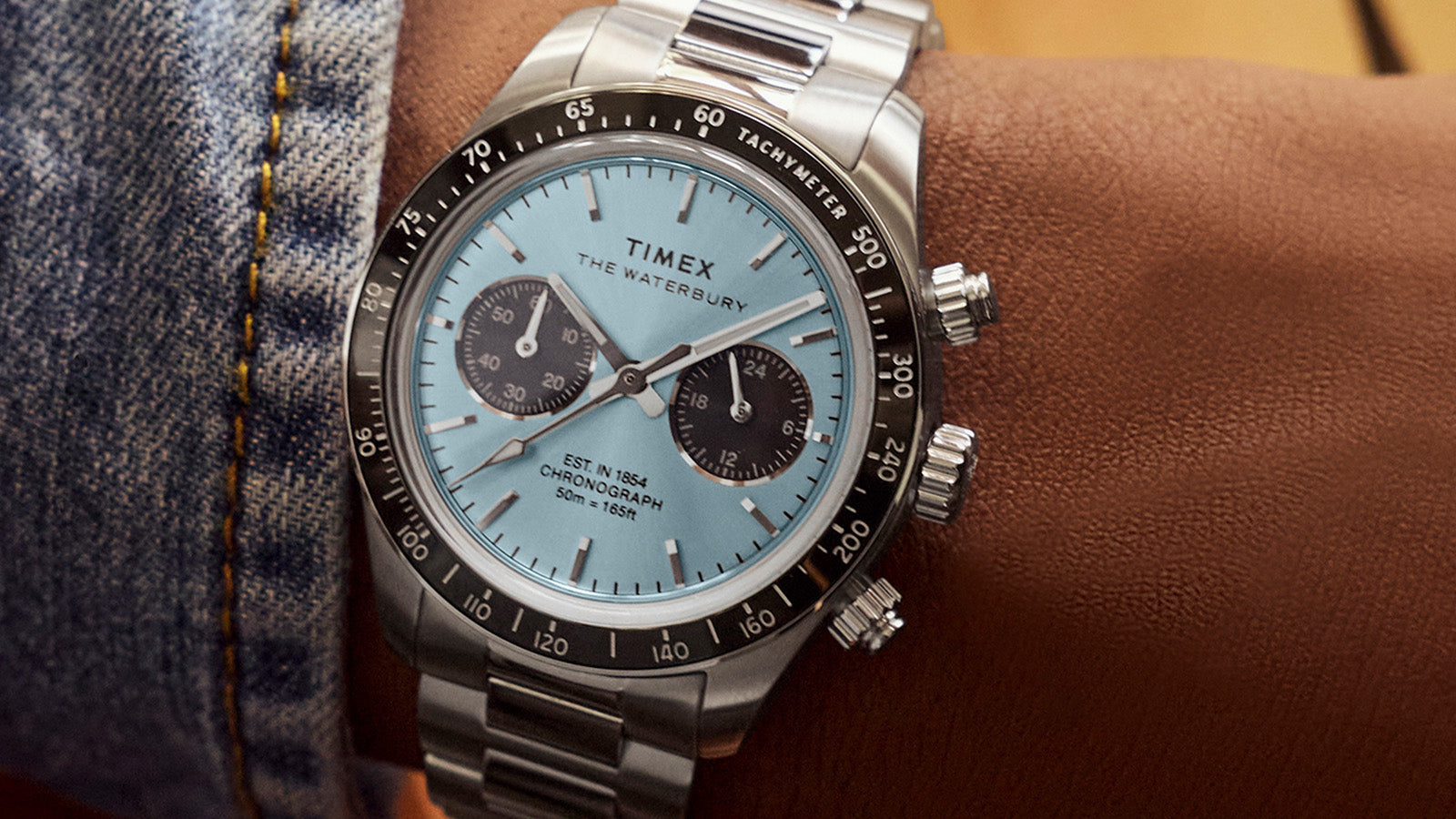 Macro view of Timex Waterbury Heritage Chronograph dial with light blue sunray finish, dual subdials, and applied hour markers.