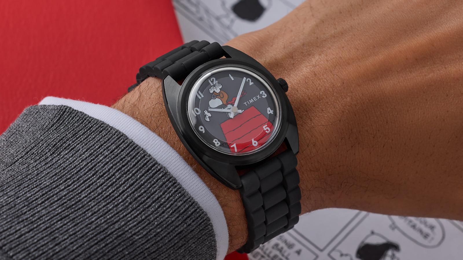 Side angle of Peanuts® x Timex 1979 Reissue Inspired watch on wrist with matte black case, black bracelet, and Snoopy Flying Ace illustration on dial.