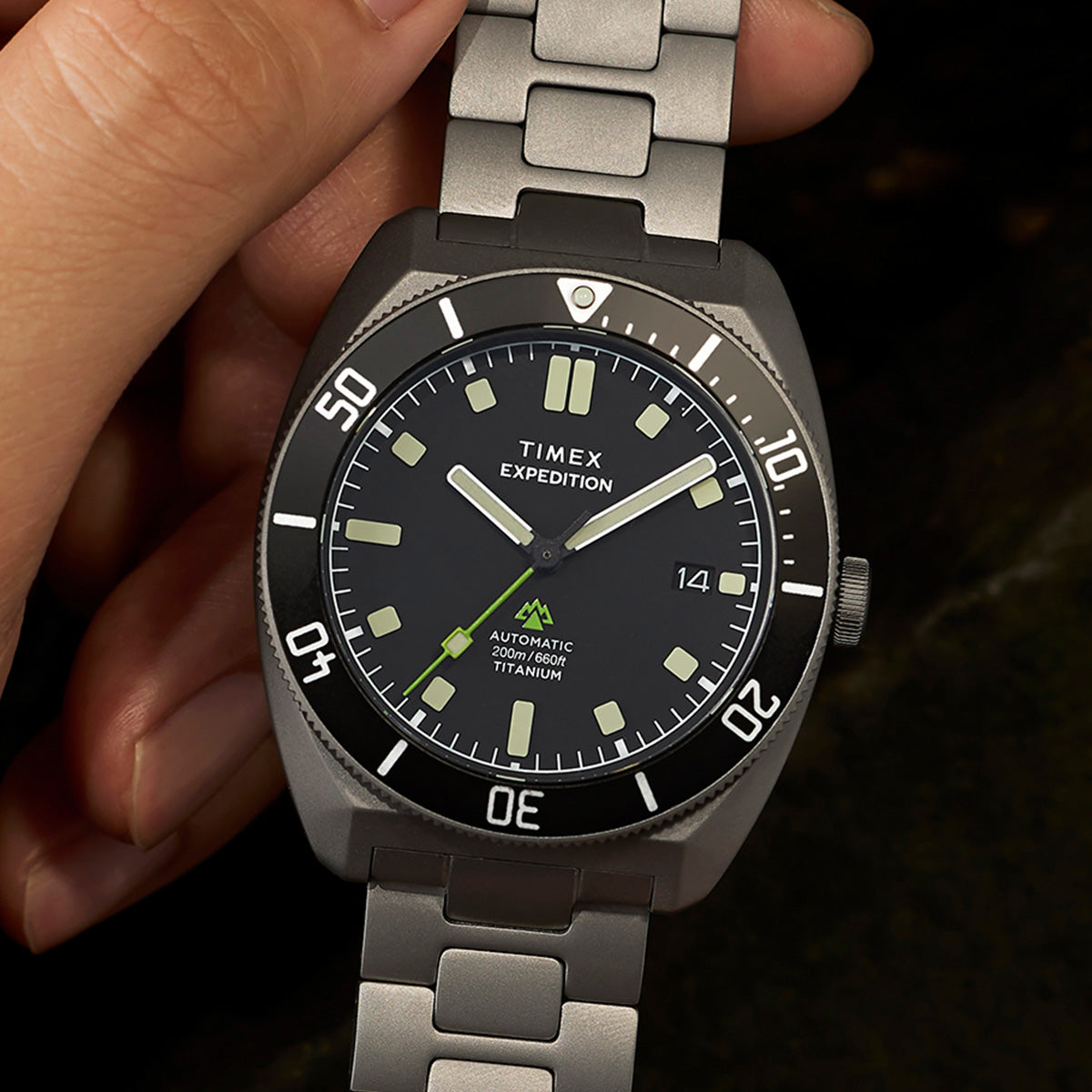 Detailed wrist shot of the Expedition® Pioneer Titanium Automatic with brushed titanium bracelet and black dive-style bezel.