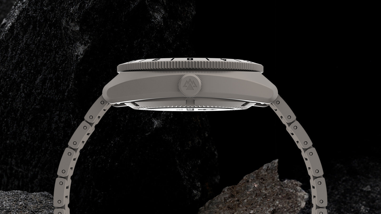 Side profile of the Expedition® Pioneer Titanium Automatic GMT showing the brushed titanium case, crown with Expedition logo, and bracelet links.