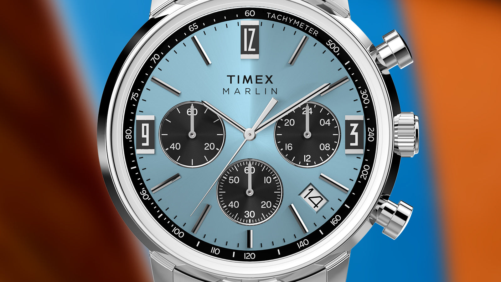 Close-up of the Timex Marlin Chronograph Tachymeter dial with a light blue sunray finish, black chronograph subdials, tachymeter scale, and date window.