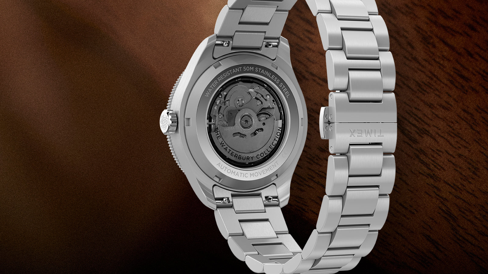 Back view of Timex Waterbury GMT automatic watch showing exhibition caseback and stainless steel bracelet.