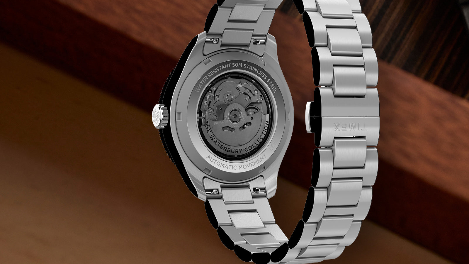 Back view of Timex Waterbury Heritage Automatic GMT watch showing exhibition caseback and stainless steel bracelet.