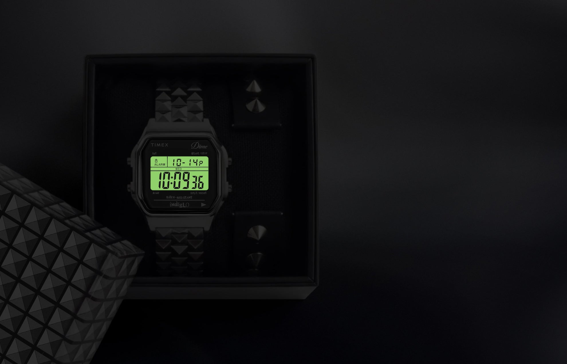 Timex x Dime digital watch in box with Indiglo backlight illuminating the digital display.