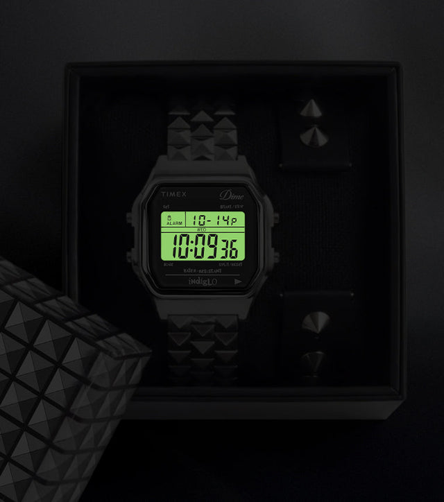 Timex x Dime digital watch in box with Indiglo backlight illuminating the digital display.