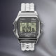 Timex x Dime digital watch with stainless steel pyramid-link bracelet and LCD display.