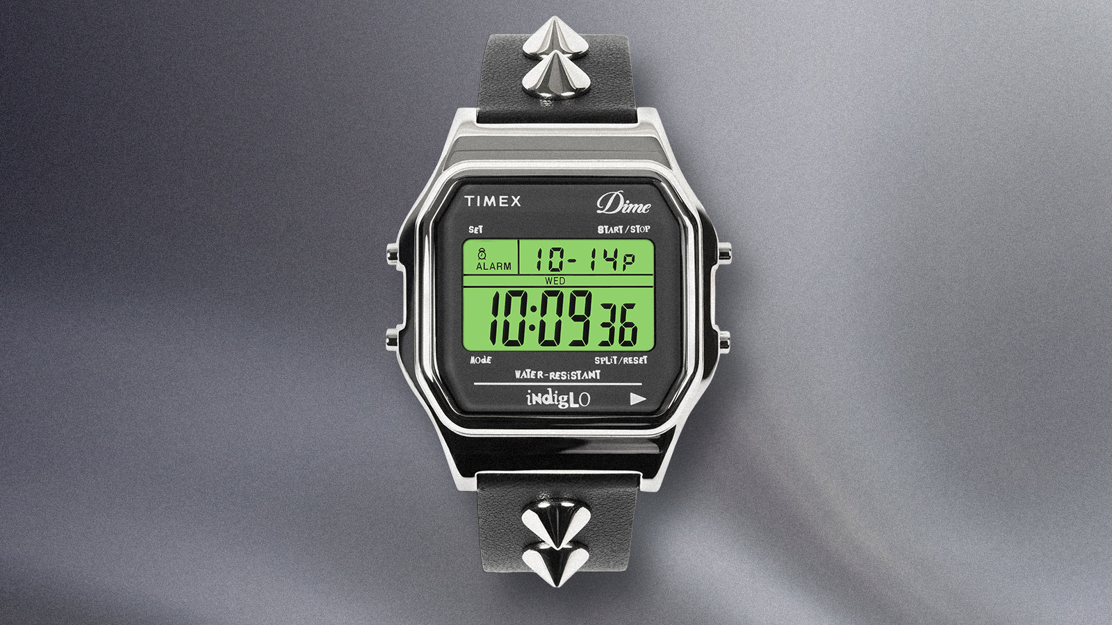 Timex x Dime digital watch with Indiglo backlight showing illuminated digital display.