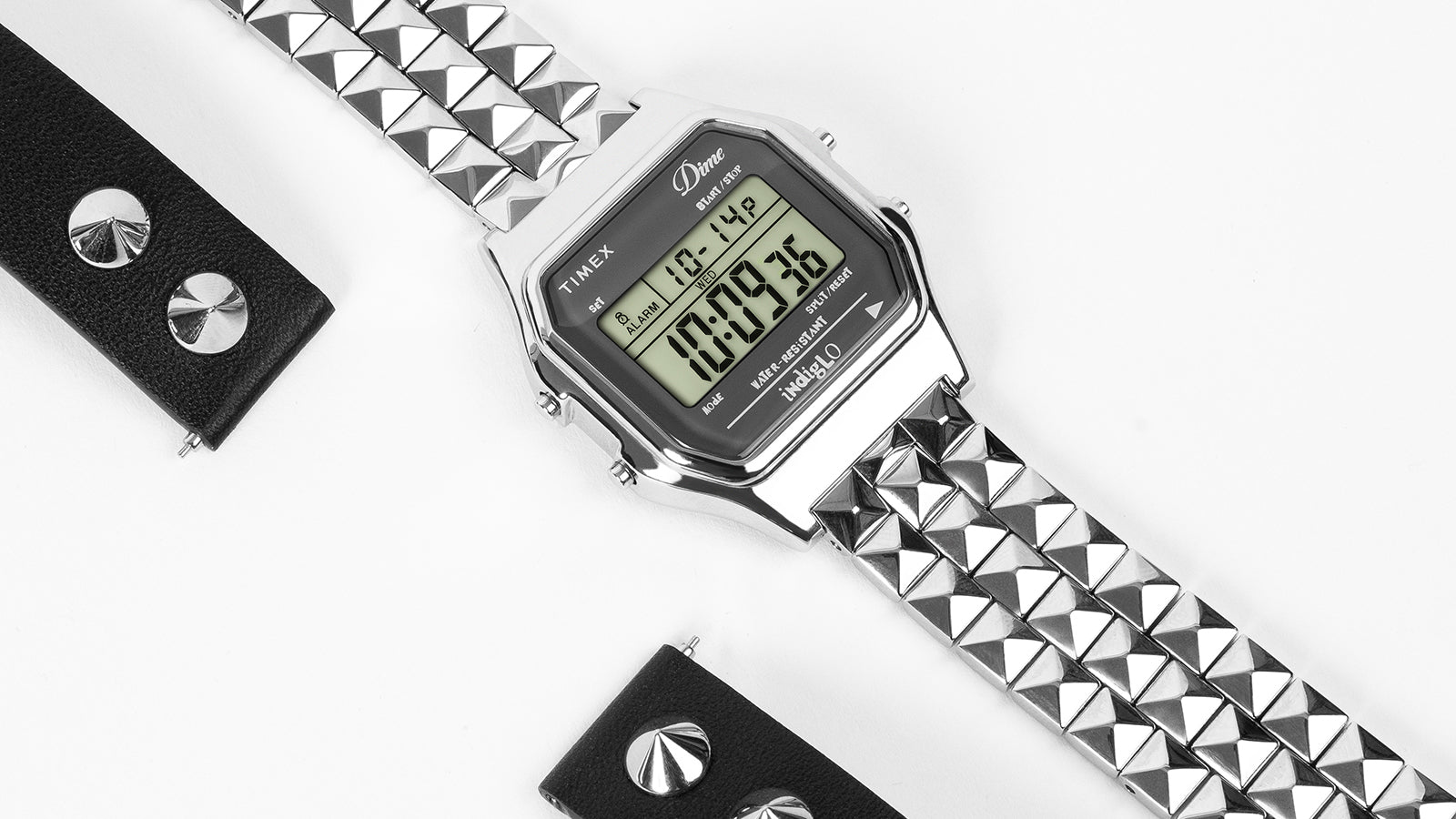 Timex x Dime digital watch with pyramid-link bracelet and studded strap detail on white background.