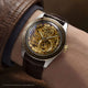 Harry Potter x Timex Waterbury Skeleton Automatic watch worn on wrist showing gold-tone skeleton dial and Hogwarts detailing.