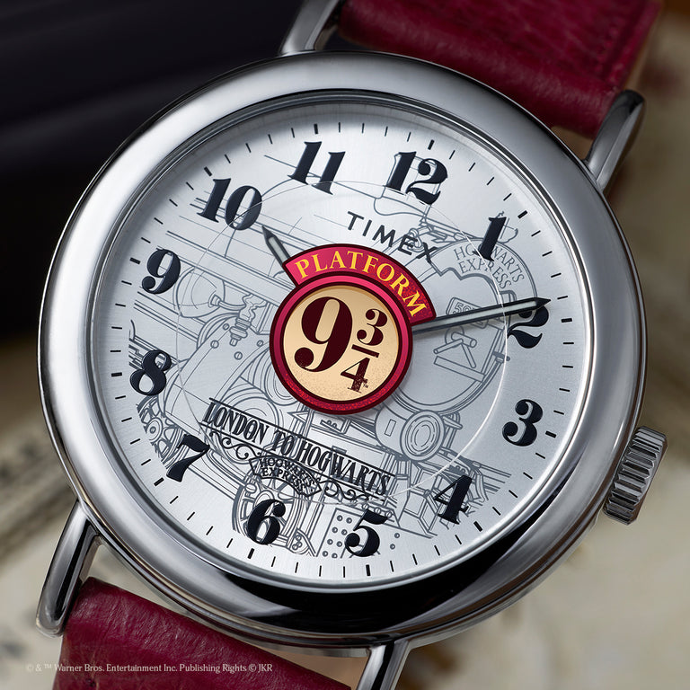 Close-up of a Timex x Harry Potter Weekender watch with a burgundy leather strap and Platform 9¾ design on the dial