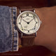 Harry Potter x Timex Weekender Hufflepuff House watch worn on wrist featuring house icons and Sorting Hat detail.