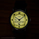 Harry Potter x Timex Weekender Hufflepuff watch illuminated in yellow INDIGLO mode showing Hufflepuff name and house crest.