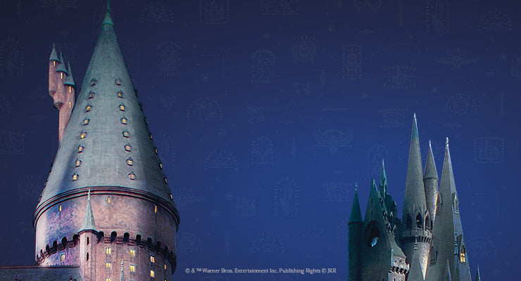 Nighttime view of Hogwarts castle towers under a starry sky, with softly lit windows and a magical blue-toned background.