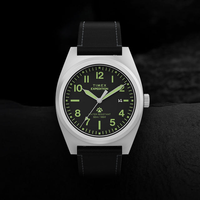 Close-up of Timex Expedition Capstone watch with black dial, Arabic numerals, and leather strap