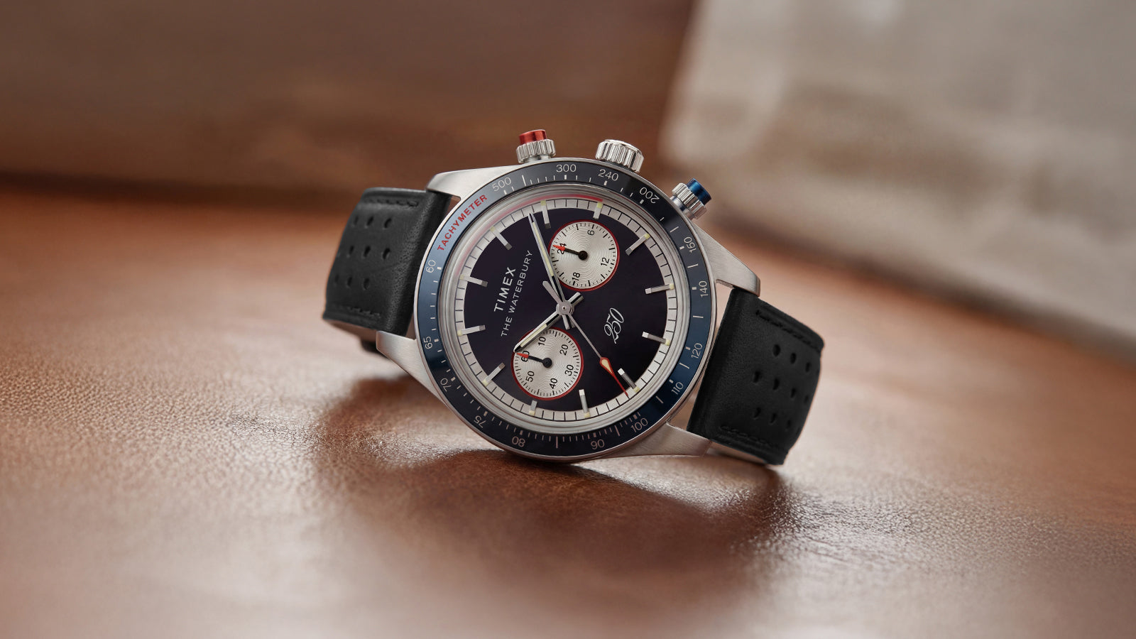 Waterbury Heritage America 250 Chronograph featuring a stainless-steel case, black dial, dual subdials, and a black perforated leather strap.