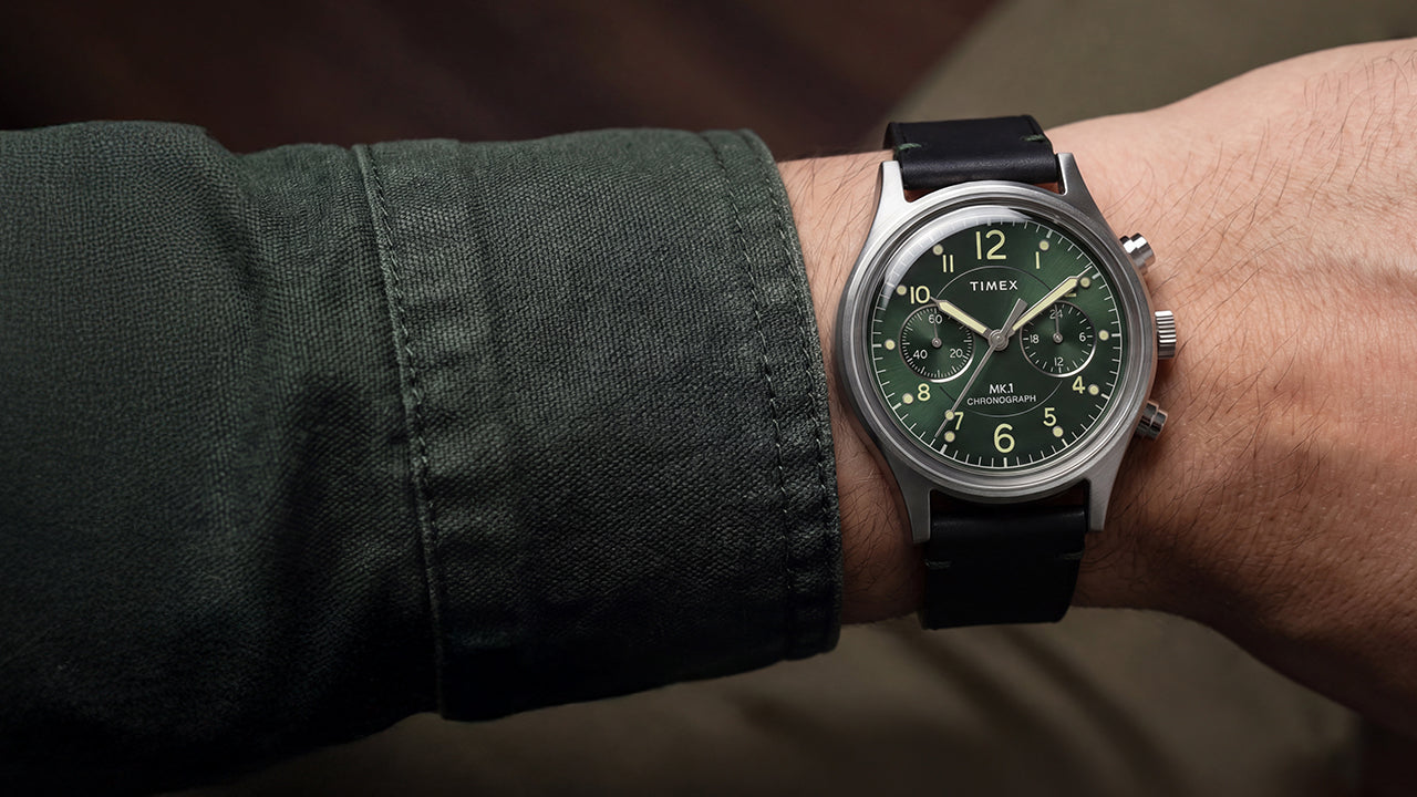 Close-up of the Timex MK1® Chronograph with a green dial and black leather strap worn on the wrist.