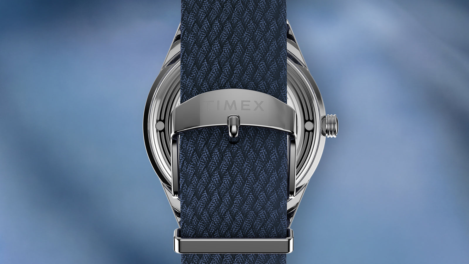Rear view of the Peanuts® x Timex Marlin® Jet Automatic Easy Rider watch showing the stainless steel caseback, signed buckle, and textured blue woven strap.