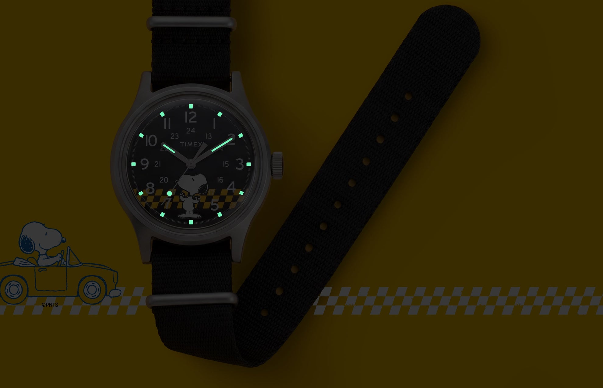 Peanuts® x Timex MK1® watch with INDIGLO® night-light illuminating the hands and hour markers, featuring Snoopy artwork on the black dial.