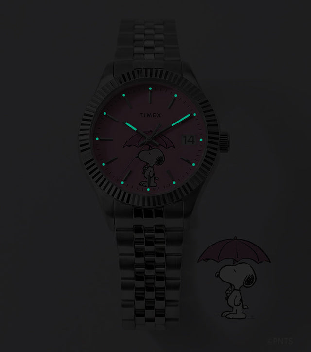 Peanuts® x Timex Legacy Snoopy Umbrella watch with INDIGLO® illumination, featuring glowing hands and hour markers against a dark background.