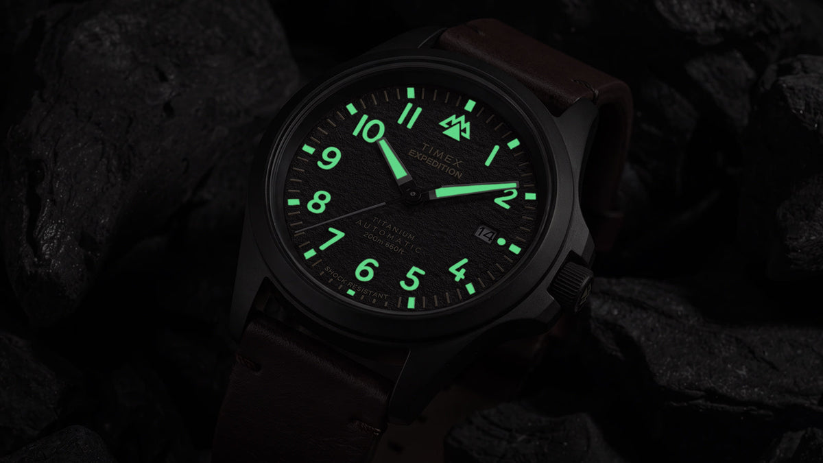 Angled view of the Expedition® Field Post Automatic titanium watch showcasing luminous hands and hour markers.