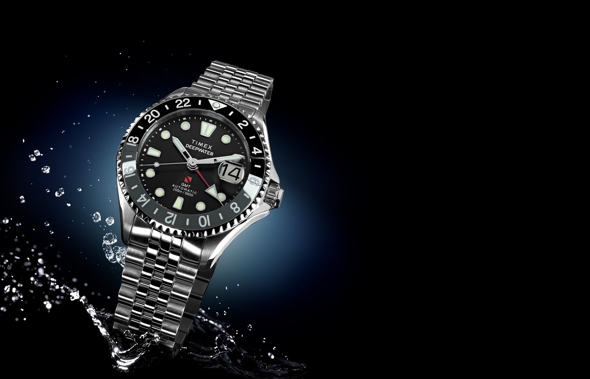 Timex Deepwater Meridian 200 Automatic GMT stainless steel watch with black dial and GMT bezel, shown with water splash accents on a dark blue background.