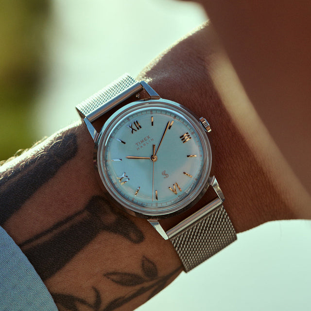 Close-up of the Todd Snyder x Timex Marlin® Mesh watch with a light blue dial and stainless steel mesh bracelet worn on the wrist.