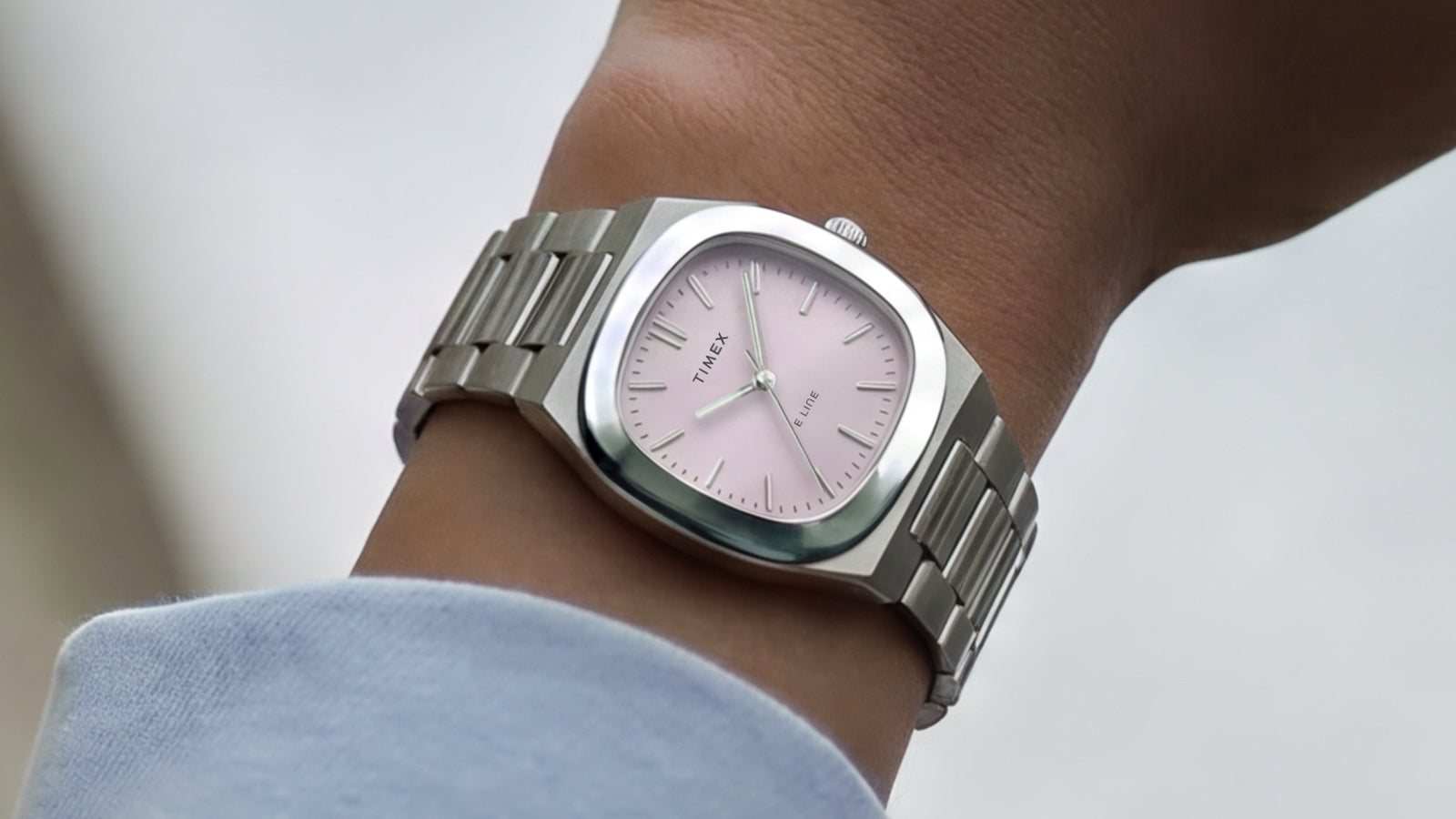 Timex® Quartz E Line 30mm stainless steel watch with a pink sunray dial worn on the wrist.